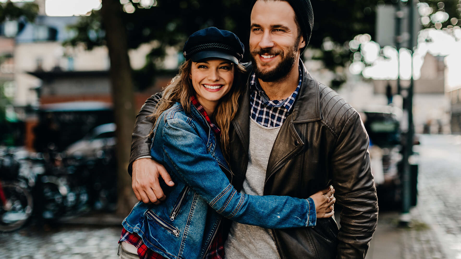 Happy young couple walking down street