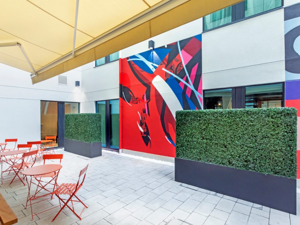 The Hendrick Dublin's courtyard with art on walls