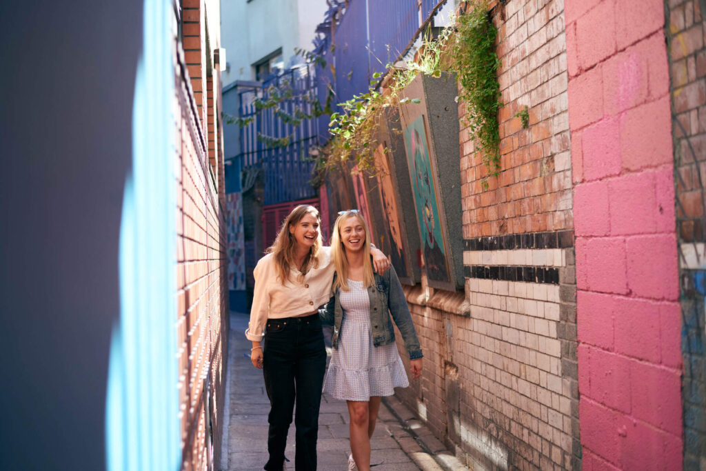 Two girls walk down love lane, a must stop on a Valentines Day stroll to the best places to eat valentines day meals