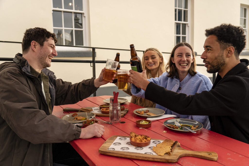 People drinking beer at an outdoor table