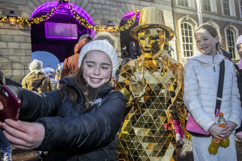 A girl and a performer stand together at the Culture Night 2024 Celebrations